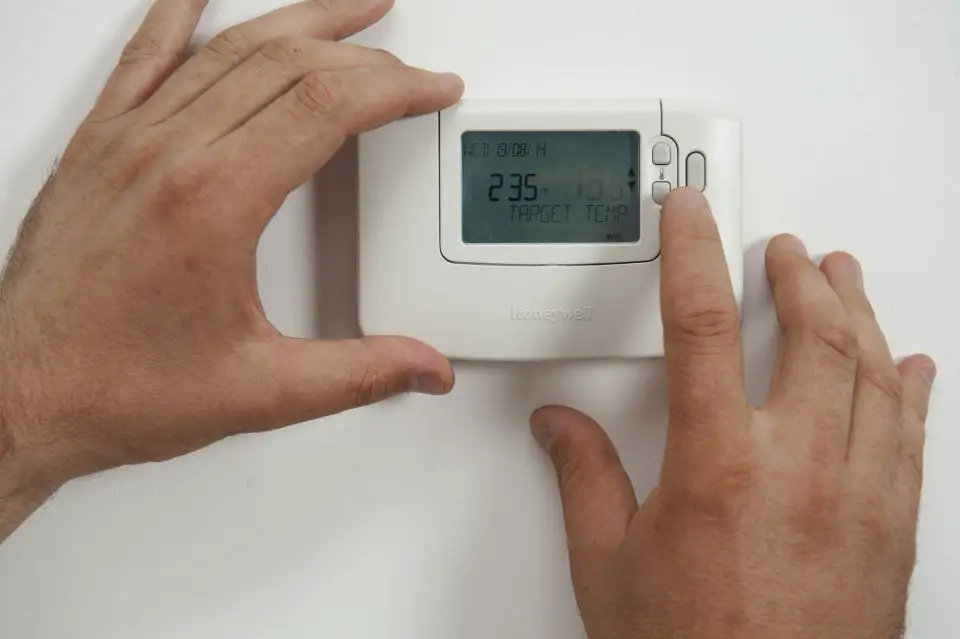 According to the Department of Energy, your HVAC system accounts for around fifty percent of your home energy costs. energy efficient HVAC thermostat setting with hands and display