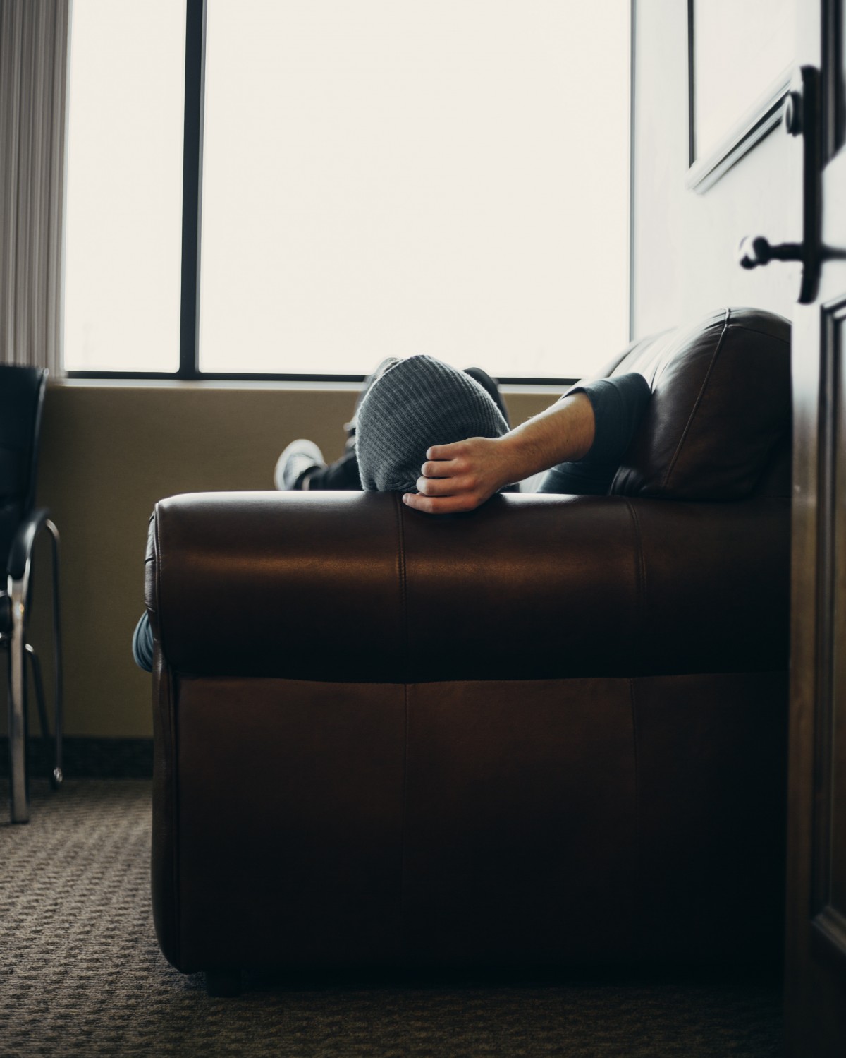 guy relaxing on couch in small minimalist room