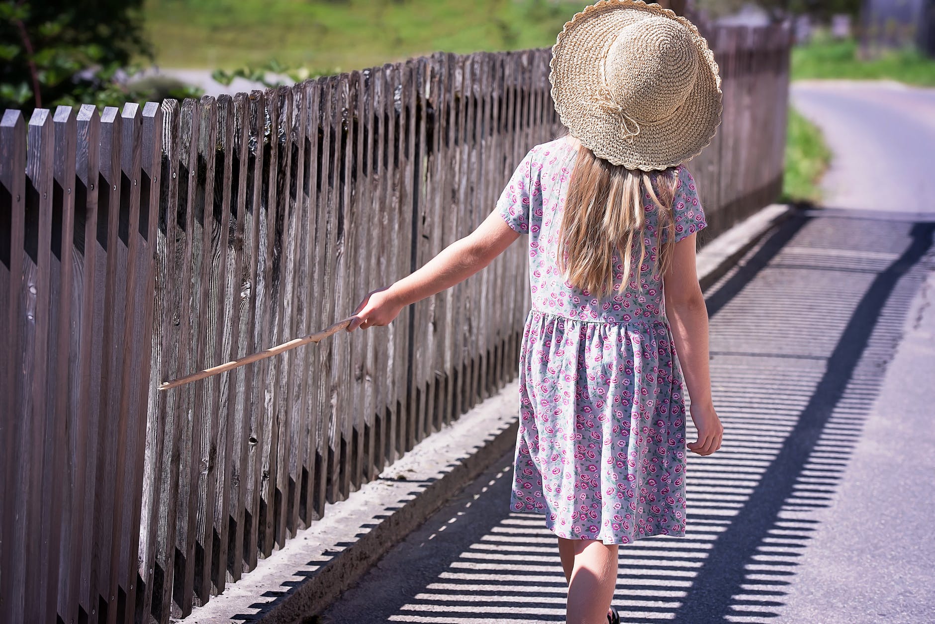 little girl by the privacy fence