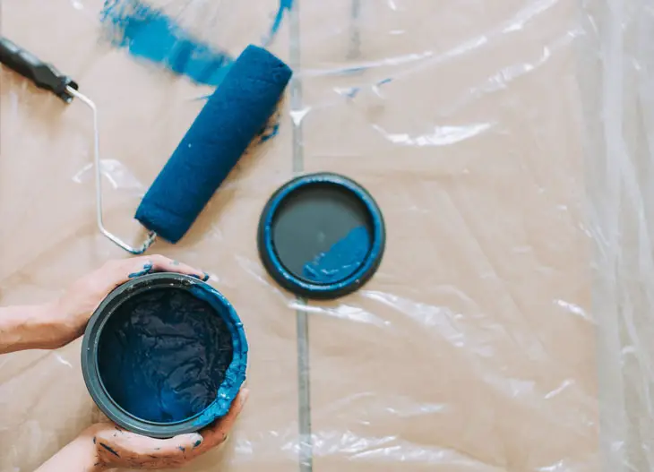 blue paint beside blue paint roller