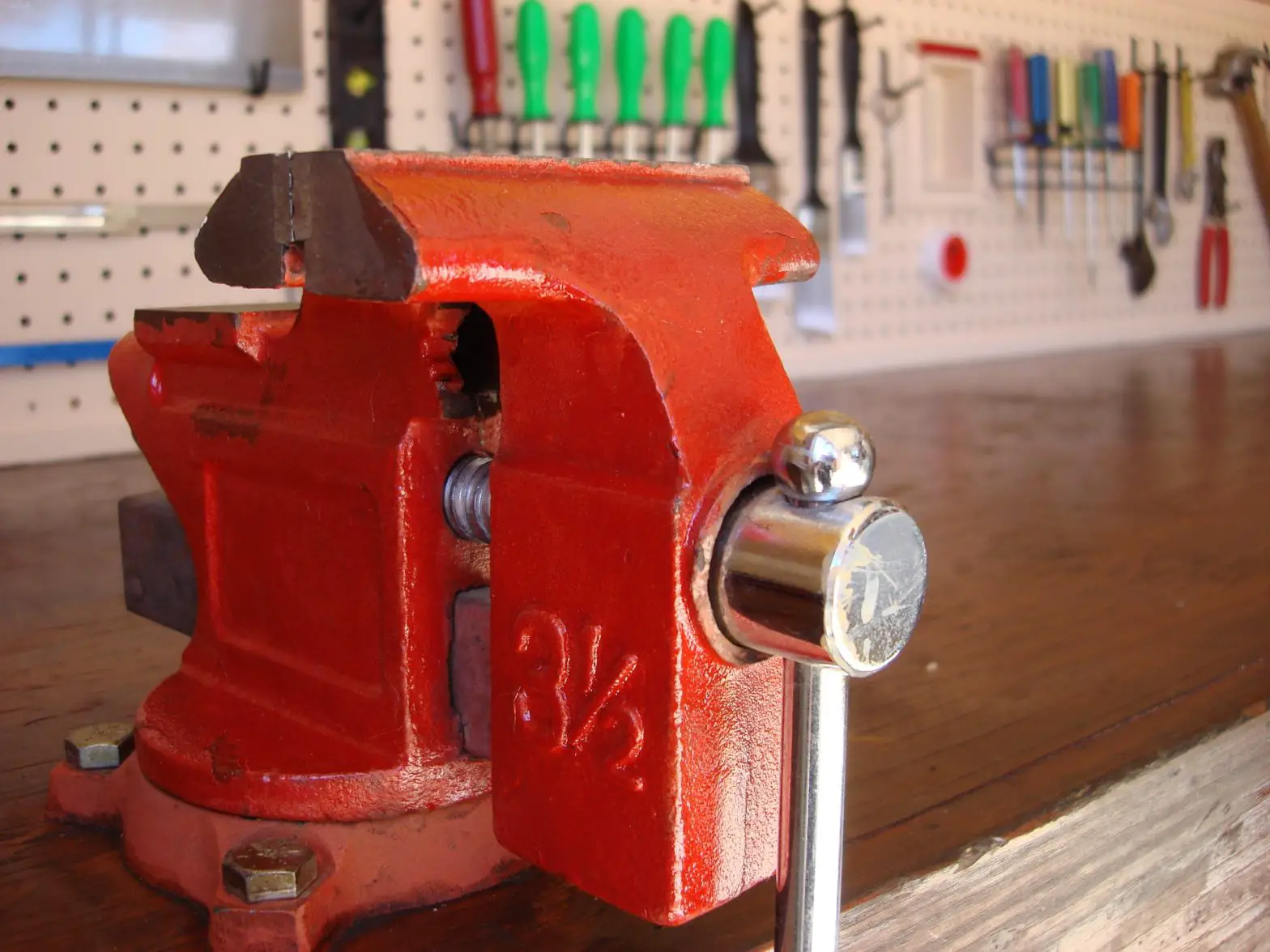 A vice grip attached to a workbench top