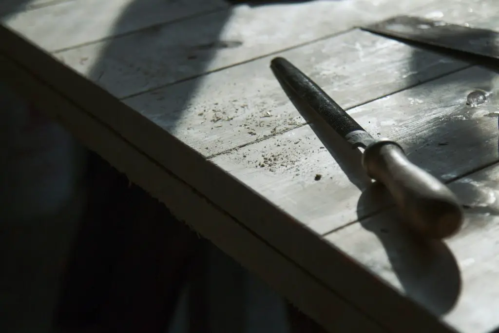 A file laying on a workbench top